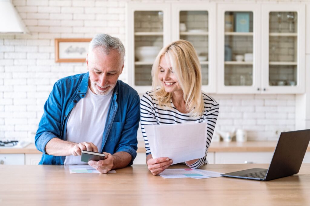 Couple comparing a cash out refinance quote with their current mortgage statement