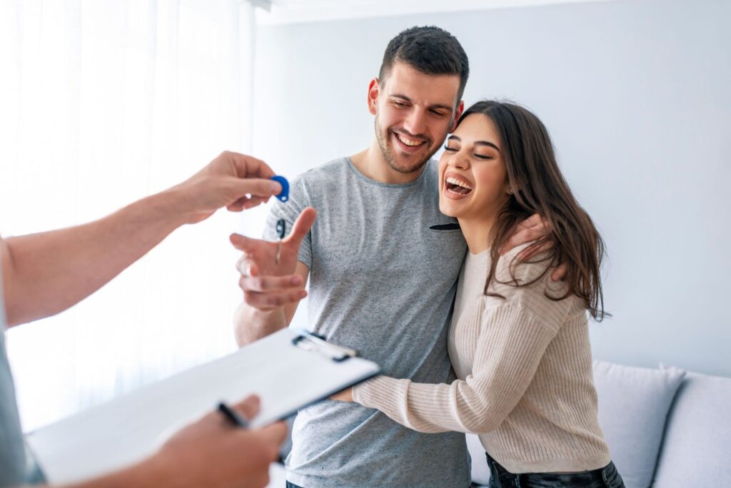 Couple receiving the keys to their first home in California at closing