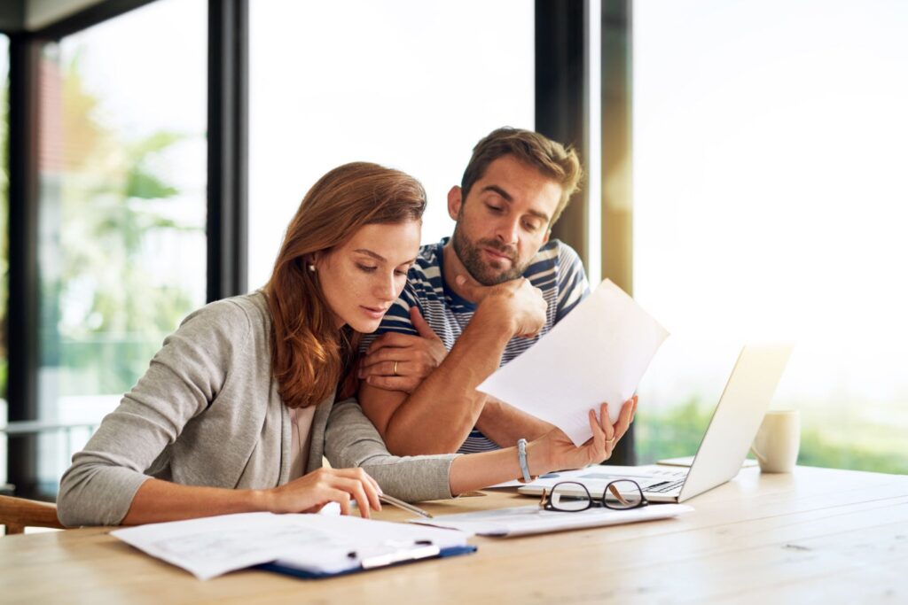 First time buyers in California reviewing their homebuying budget and loan documents at home