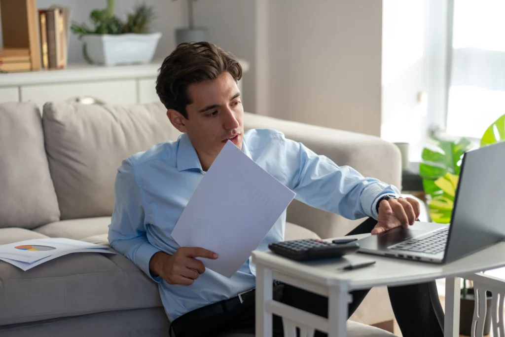 Self employed borrower organizing bank statements and tax documents before applying for a mortgage